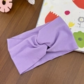 Detail view of lavender purple cross-knot baby headband in soft elastic knit fabric - Purple