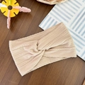 Detailed view of beige cable-knit baby headband featuring a twisted knot and elastic texture - Apricot