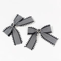 Detail of plaid bow hair clips with black lace trim and heart-shaped gemstone center - Black Heart