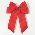 Detailed macro view of the grooved texture on a large red grosgrain ribbon hair bow - Red