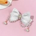 Detail of white satin bow hair clip with pearl tassels and rhinestone centerpiece - White