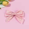 Detail showing high-quality pink satin ribbon fabric and texture on this bow hair clip - Pink