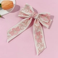 Detail der floralen Stickerei auf der Jacquard-Schleife-Haarklammer in Pink - Rosa