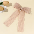 Detail of a pink chiffon bow hair clip with textured fabric and a white faux pearl charm - Pink Pearl Pendant Style