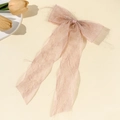 Detail of light pink chiffon bow hair clip with long ribbons on a warm beige background - Pink Long Streamer Style