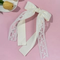 Detailed view of elegant cream lace bow hair clip with floral embroidery and satin ribbon - Beige