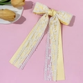 Detalle de la pinza para el pelo con lazo de satén amarillo claro y encaje blanco - Amarillo