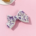 Détail du nœud barrette crème avec broderie jacquard vintage en violet et fil d'or - Violet