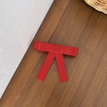 Detail shot of the red grosgrain ribbon bow hair clip on a natural wooden background - Red
