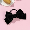 Detailed macro view of a dark green velvet double-layer bow hair tie on a pink background - Dark Green