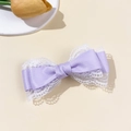 Detailed view of the purple satin bow hair clip with intricate white lace trim edges - Purple