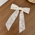 Eleganter weißer Spitzenbogen Haarclip mit rosa Naht und langen Bändern auf Holz - Rosa