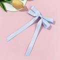 Light blue ballet-style satin ribbon bow hair clip on a pink aesthetic background - Blue