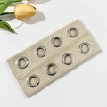 Detail of beige ribbed elastic headband with silver metal eyelets and soft knit texture - Beige