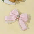Detail of pink satin bow hair clip with white lace trim and pearl pendant drop - Pink
