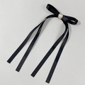 Detail of elegant black satin bow hairclip featuring double layers and a pearl center - Black