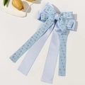 Close-up of light blue double-layered bow hair clip with floral embroidery and satin ribbons - Blue