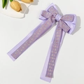 Detail of purple silk bow hair clip with intricate floral jacquard on long ribbons - Purple