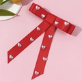 Elegant red bow hairclip with white heart pearls and long ribbons on pink background - Red