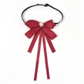 Detailed view of wine red satin bow tie with sparkling rhinestone and pearl brooch center - Elastic Band Style / Burgundy