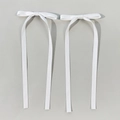 Close-up of a pair of white satin bow hair clips with long ribbons and metal alligator clips - White