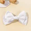 Close-up of white satin bow hair clip showing smooth fabric texture and layered design - White