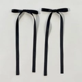 Detail of pair of black satin ribbon bow hair clips with long dangling streamers - Black