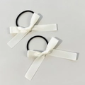 Close-up of white satin bow hair ties with elastic bands in a set of two pieces - Beige