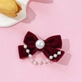 Elegant burgundy velvet bow hair clip with vintage pearl chain tassels on a pink surface - Burgundy