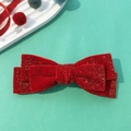 Detail einer roten Samtschleife-Haarspange mit Goldglitzer-Textur und doppellagigem Design - Rot