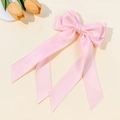 Detailed view of pink satin bow hairclip with ruffled lace edges and long flowing ribbons - Light Pink