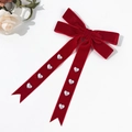 Detail of red velvet bow hair clip with heart pearls and long flowing ribbons - Red