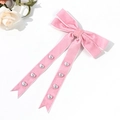 Pink velvet bow hair clip with long ribbons and silver heart studs on white background - Pink