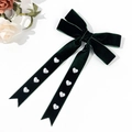 Detail of dark green velvet bow hair clip featuring heart-shaped pearls and long ribbon tails - Dark Green