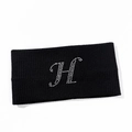 Macro detail of black knitted yoga headband featuring a sparkling rhinestone H initial - Letter H Style