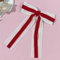Detail of red velvet and white lace bow hair clip featuring elegant long ribbon streamers - Red