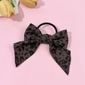 Close-up of a leopard print bow scrunchie with denim texture on a soft pink background - Dark Brown Leopard Swallowtail Bow Scrunchie (8#)