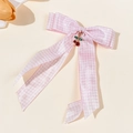 Close-up of pink plaid bow hair clip featuring a delicate cherry pendant with rhinestones - Light Pink