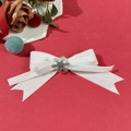 Detail of white velvet bow hair clip with silver snowflake charm for Christmas - White