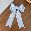 Detail of light blue satin bow hair clip with elegant pearl chain and dangling pendant - Blue