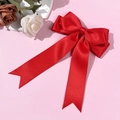 Elegant large red satin ribbon bow hair clip with long streamers on pink background - Red