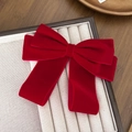 Elegant large red velvet bow hair clip with ribbons on a beige jewelry display box - Red