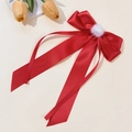 Macro detail of red satin bow hair clip with white pompom and long ribbons - Red