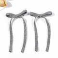 Elegant pair of blue-grey tweed bow hair clips with long ribbons on white background - Gray