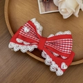 Detail of red gingham bow hair clip with white lace trim and heart pearl accents - Red