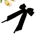Detail of elegant black velvet bow hair clip with large centered pearl and gold trim - Black