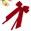 Elegant red velvet bow hair clip with pearl embellishment and long streamers on white background - Red