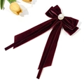 Detail of burgundy velvet bow hair clip featuring a white pearl with a gold rim accent - Burgundy