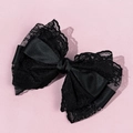Close-up of elegant black lace bow hair clip with layered satin and floral patterns - Black