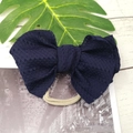 Detailed close-up of dark blue lace bow hairband with soft nylon elastic for infants - Navy Blue